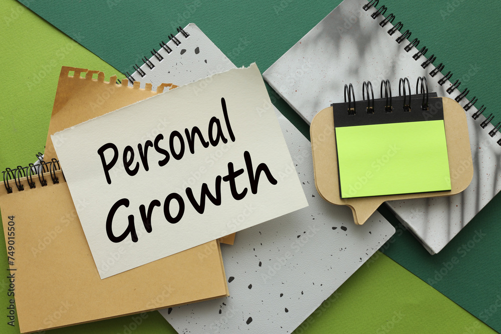 personal GROWTH different pages on a green background. text on paper