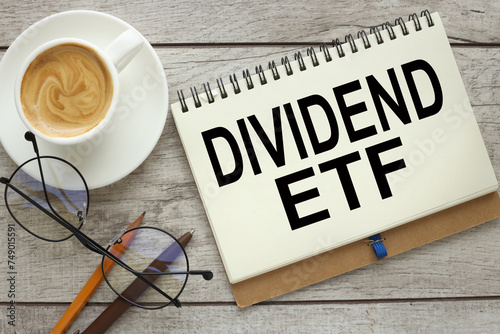 devidend ETF On a white background magnifier, a pen and a sheet of paper with the text photo