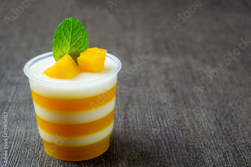 pudding mangga or mango layer pudding. topped with mango pieces and mint leaves. Very fresh and healthy