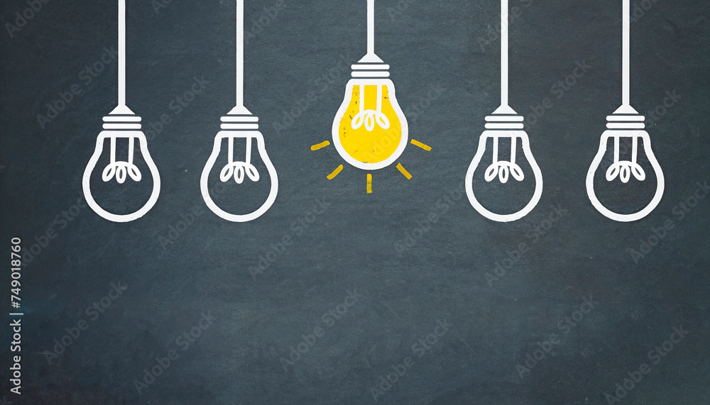 Concept of idea, creativity, imagination. An on light bulb stands out from other off ones, isolated on black background with copy space for your text. Concept of idea, creativity, imagination. An on light bulb stands out from other off ones, isolated on black background with copy space for your text.