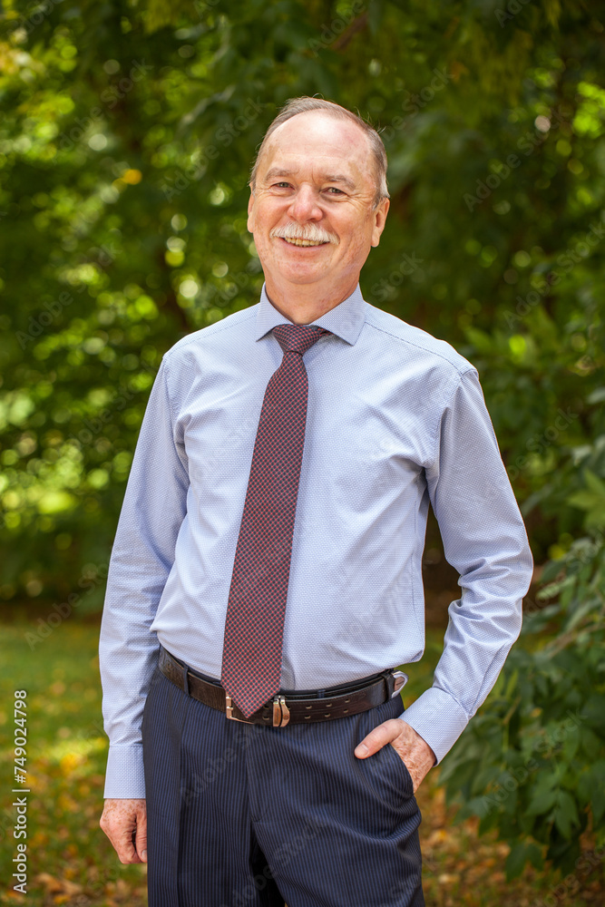 Portrait of an elderly happy man in a blue shirt Portrait of an elderly happy man in a blue shirt