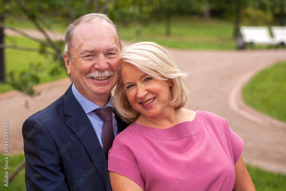 Portrait of an elderly happy couple in a summer park