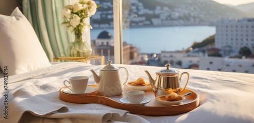 tea and cake on a tray on a bed with views