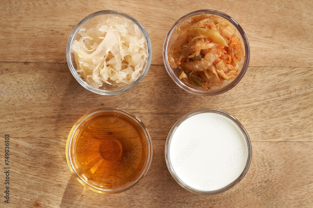 Fermented foods in glass bowls - kimchi, sauerkraut, apple cider vinegar and kefir Fermented foods in glass bowls - kimchi, sauerkraut, apple cider vinegar and kefir
