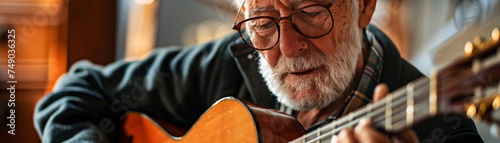 Close up of a senior playing a guitar illustrating the timeless nature of music and personal expression photo