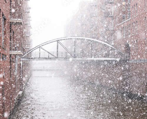 Hamburg warehouse district bridge over river in winter snow