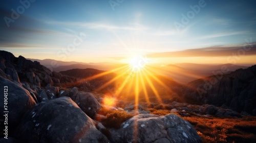 a sun shining through the clouds over a rocky mountain photo
