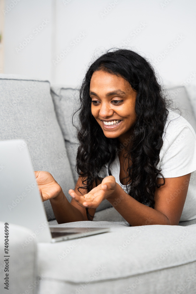 Vertical frame of brunette woman having video call in the living room Vertical frame of brunette woman having video call in the living room