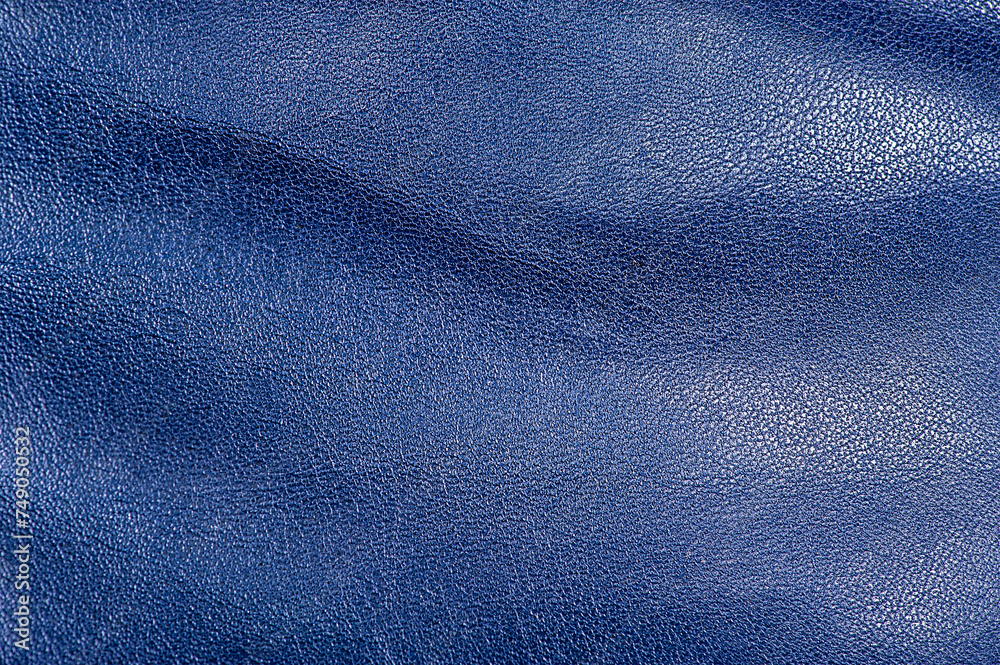 Tanned leather is painted blue. Blue leather background macro. The texture is blue. Tanned leather is painted blue. Blue leather background macro. The texture is blue.
