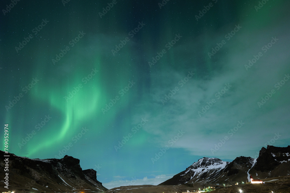 Northern Lights and Clouds in Iceland in the Winter Night Sky in Vik