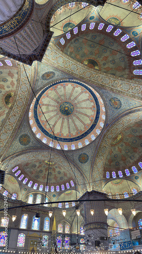 panoramic vertical of the ceiling of the blue mosque in istanbul  with colorful stained glass windows  its large arches  impressive ceiling with its central vault  Sultan Ahmed Mosque  kaleidoscope