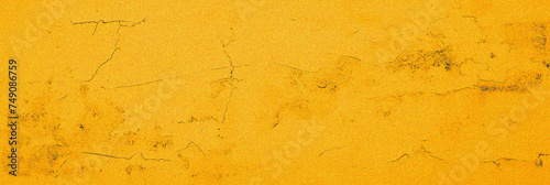 Yellow trendy grainy cement grunge textured background. Gold amber noise cracks wall. Old vintage wide backdrop design banner