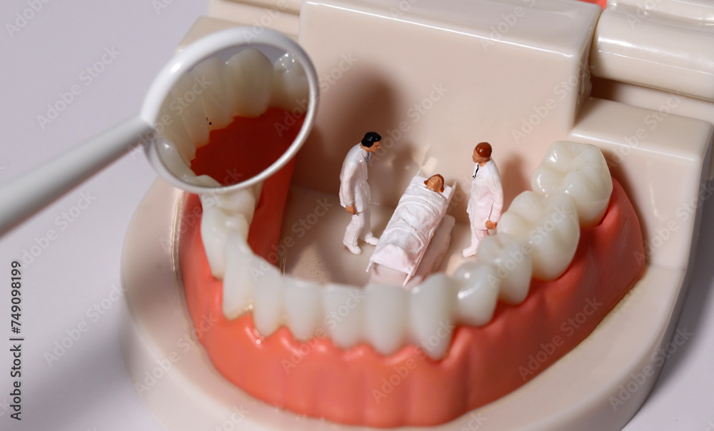 Miniature doctors and patients reflecting tooth decay in a mirror. Concepts of health care and business.
