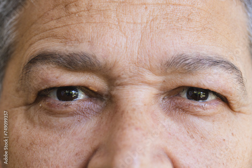 Close-up of a senior biracial man's eyes, revealing fine lines and a calm expression photo