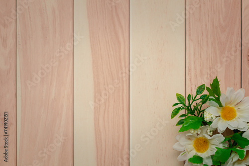 White daisies on wooden bac...
