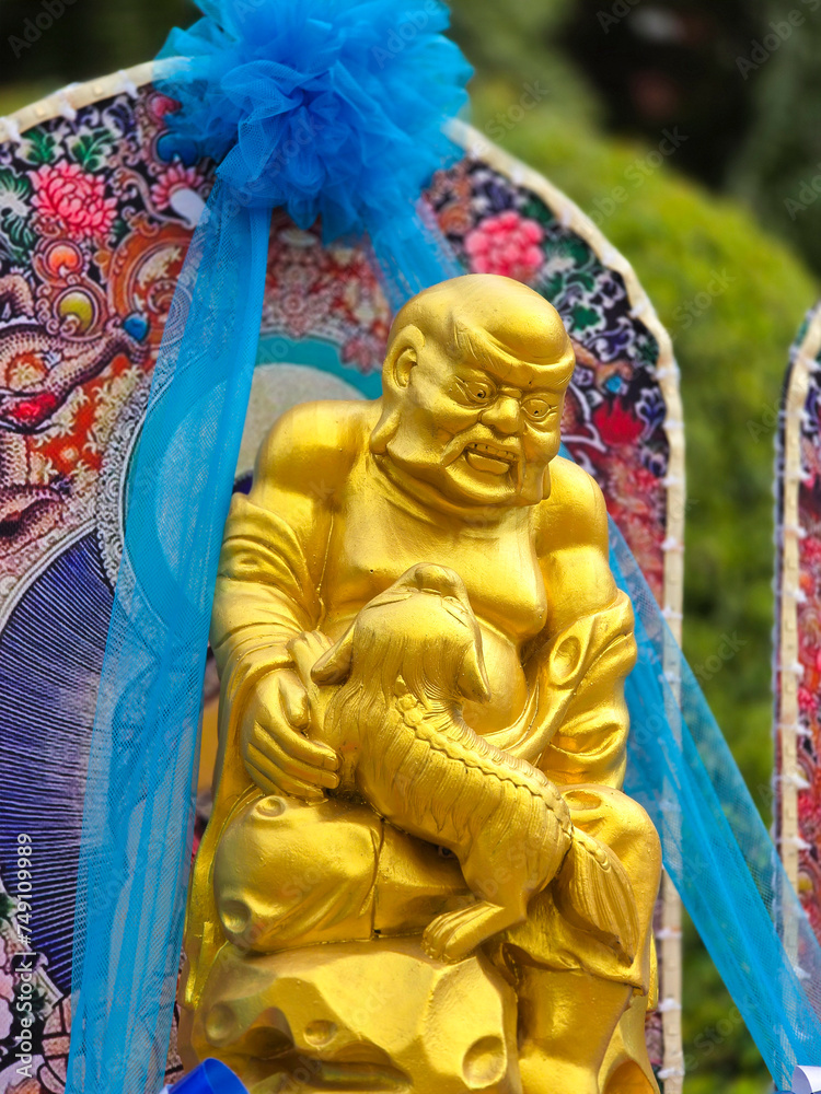 Fototapeta premium Golden statue of Arhat, Buddha, God in Oriental Culture.