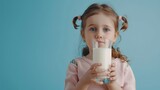World milk day. Cute little girl drinks milk. Copy space. Capturing the joy of milk-drinking on World Milk Day.