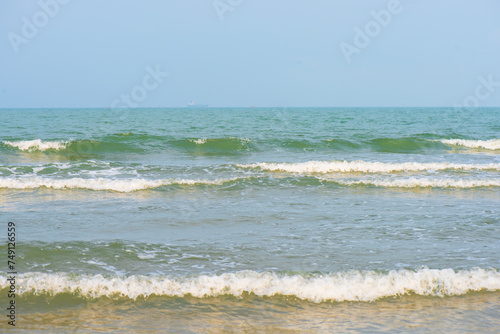 Waves on the beach. Blue sea wave. Blue water surface texture with ripples, splashes, and bubbles. Abstract summer banner background Water waves in sunlight with copy space cosmetic moisturizer.