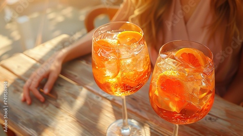 Close up of two aperol spritz drinks on sunny beige background