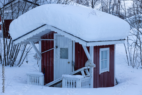 Fairy cubby house with pony outside in frosty Muonio in deep Winter in northern Finland, above the arctic circle photo