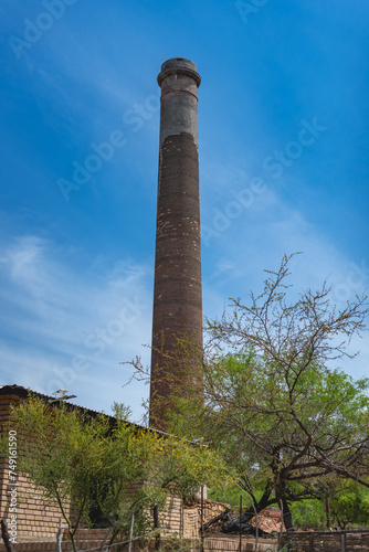 A notable feature of the town is the 47-meter-high smokestack constructed in 1890 for El Progreso Mining Company "La Ramona", named after Saint Raymond. El Triunfo, Baja California, Mexico. 