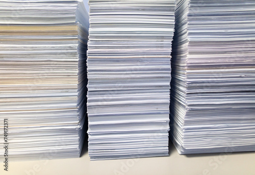 Stacks of papers on a table in the office