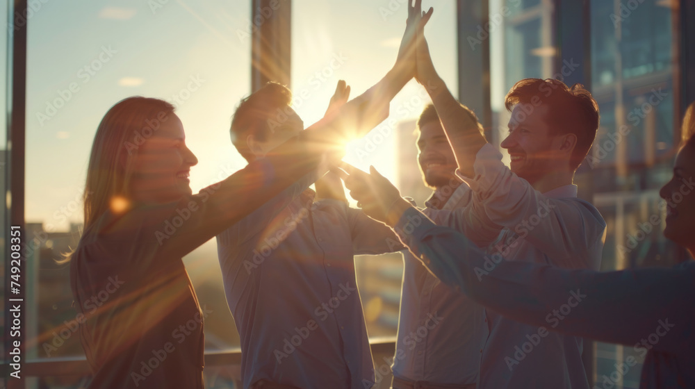 group of professionals in a vibrant office setting, enthusiastically engaging in a team high-five, signifies a moment of celebration or achievement.