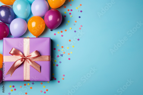 Gift box with ribbon and balloons on a blue background, top view. Generated by artificial intelligence