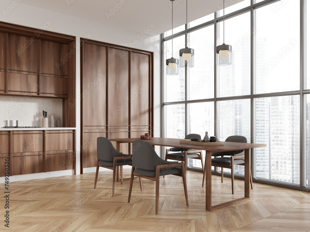 Fototapeta premium Stylish home kitchen interior with cooking and dining table, panoramic window