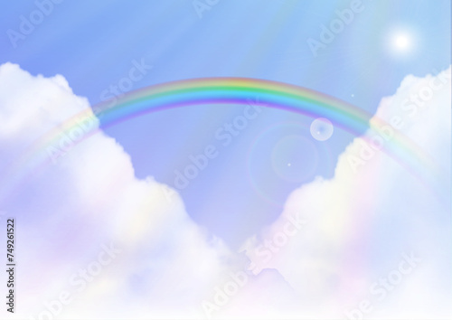 Rainbow on blue sky background 虹のかかった日が差し込む雨上がりの空
