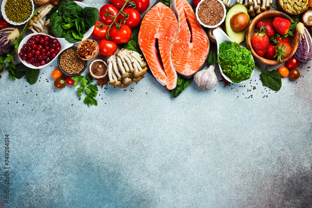 Top view. Healthy food selection on gray background. Detox and clean diet concept. Foods high in vitamins, minerals and antioxidants. Anti-aging foods. - obrazy, fototapety, plakaty 