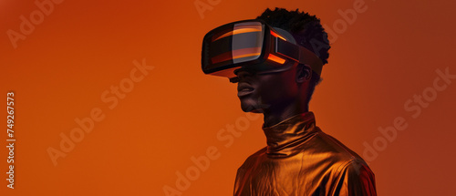 Engaged in the virtual realm, a fashionable male model combines sleek technology with contemporary style against a monochromatic backdrop