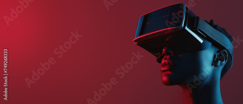 A stylish young man engages with virtual reality technology against a vibrant red backdrop, depicting modern entertainment