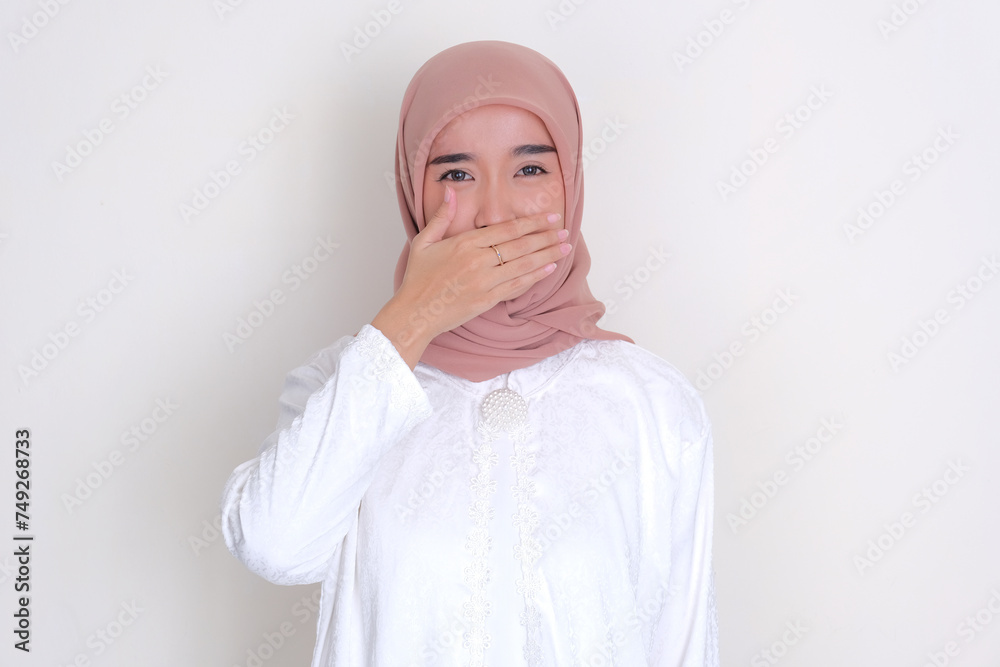Fototapeta premium Moslem Asian woman covering her mouth because of bad breath