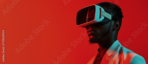 An elegant man in a suit is fully immersed in a virtual experience, represented by the sleek VR glasses