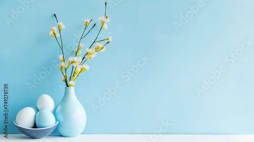 Elegant composition with vase with fresh spring branches with flowers and a bowl with eggs on light blue background.Created with AI.