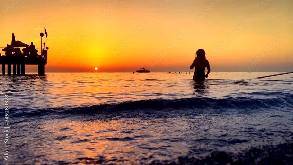 People enjoy summer beach holiday during sunset