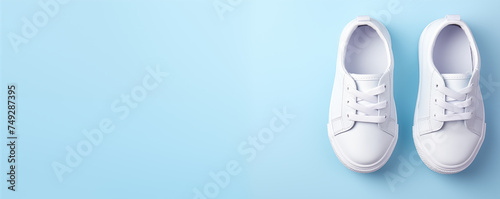 White color of kids' sneaker shoes, Advertising products, banner with copy space isolate on blue background