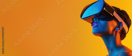 An amazed woman tilts her head upwards while wearing a VR headset on an orange background, illustrating amazement in technology