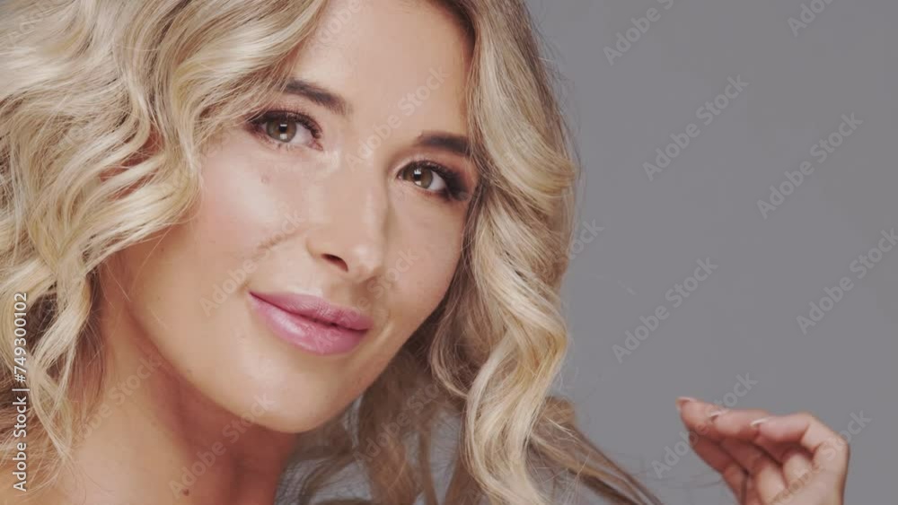 Studio portrait of young and beautiful blond woman over grey background. Skin care and wellness concepts. Studio portrait of young and beautiful blond woman over grey background. Skin care and wellness concepts.