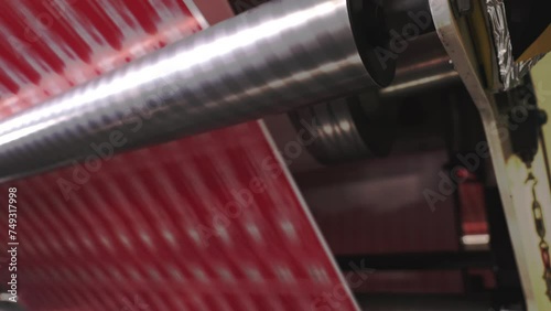 The Inside Scoop on Label Roll Production Process. Labels passing through rollers. Close Up.