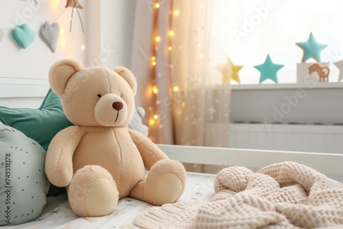 White plush teddy bear on wooden bed in nursery room for comfort