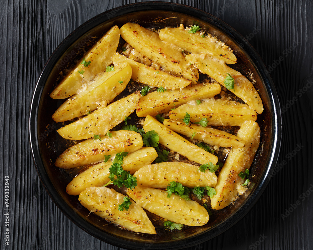 greek lemon potatoes with garlic, cheese on dish greek lemon potatoes with garlic, cheese on dish