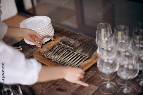 Tray with cutlery. The waiter serves the table. Catering, restaurant, service. A solemn event