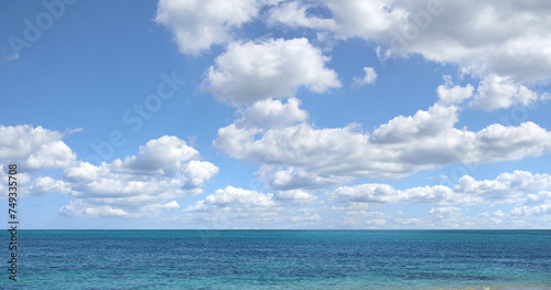 Blue sky  ocean and clouds with horizon background for peace  nature and environment with skyline seascape of tropical beach. Calm water  sea and earth with location for break or vacation with view