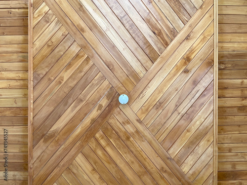 a white light bulb on the brown wooden ceiling of the mosque building