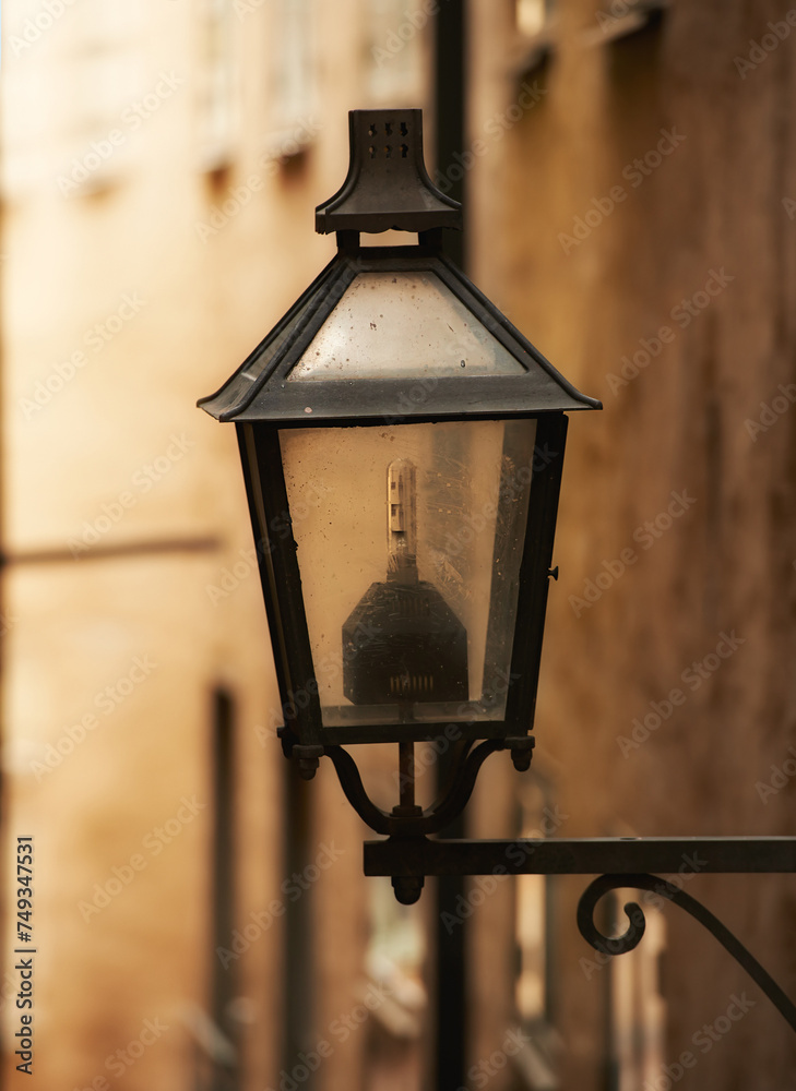 Travel, architecture and lamp on retro building in old town with history, culture or holiday destination in Sweden. Vacation, landmark and antique lantern in Stockholm with vintage light ancient city
