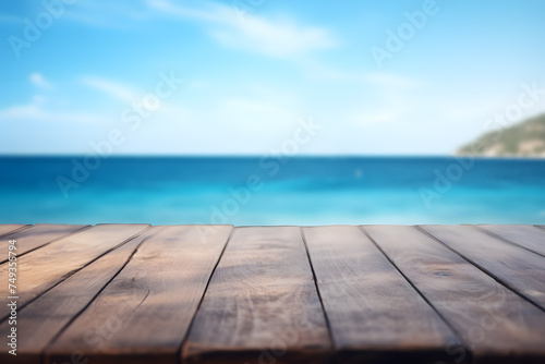 Empty wooden board with blue ocean in blurry background