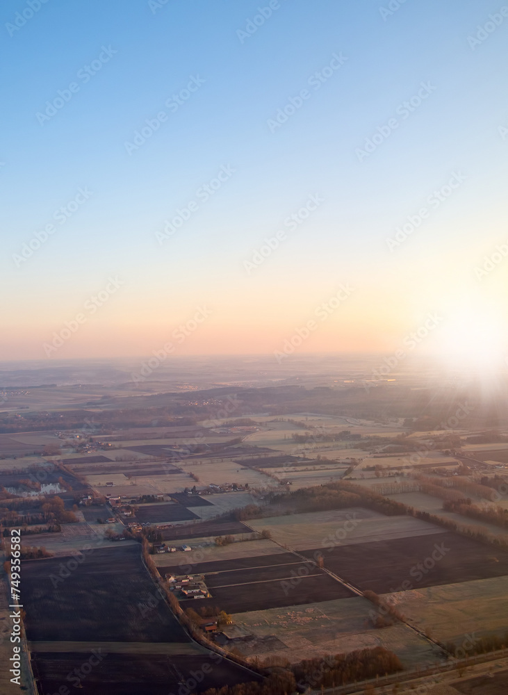 Town, aerial view and countryside in outdoors at sunset, field and sustainable environment on travel. Blue sky, peace and mockup space in nature, drone and town for ecosystem at dusk or landscape
