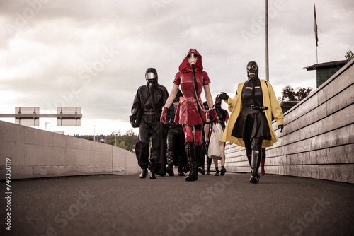 A group of people in Latex and Rubber walking fully masked in public photo